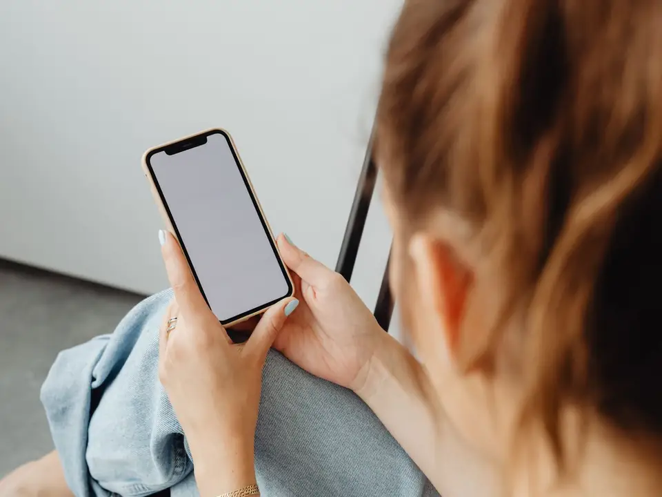 Person browsing on a phone, where a remarketing ad can remind a past website visitor about a business
