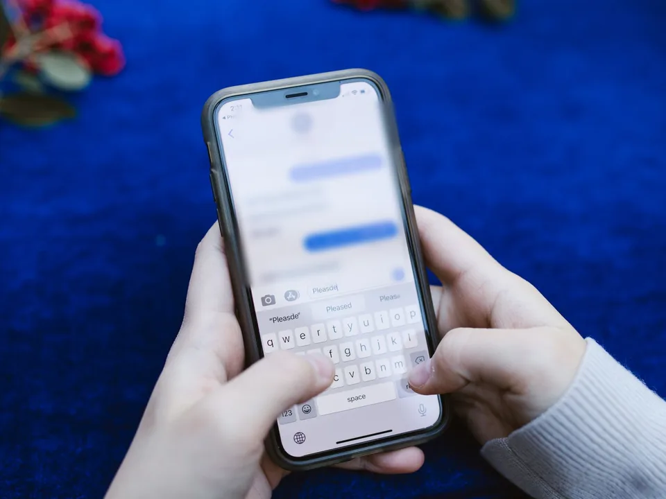Hands typing a reply in a chat app on a smartphone, the kind of conversation a click-to-WhatsApp ad starts