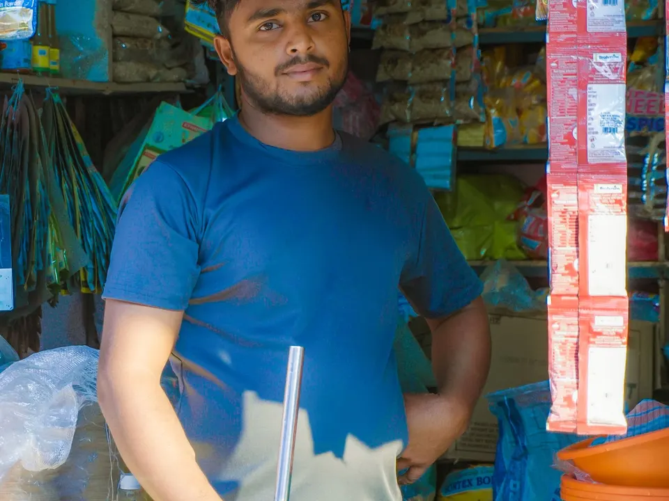 Small business owner standing in his neighbourhood shop, the kind of Coimbatore small business SEO is built for