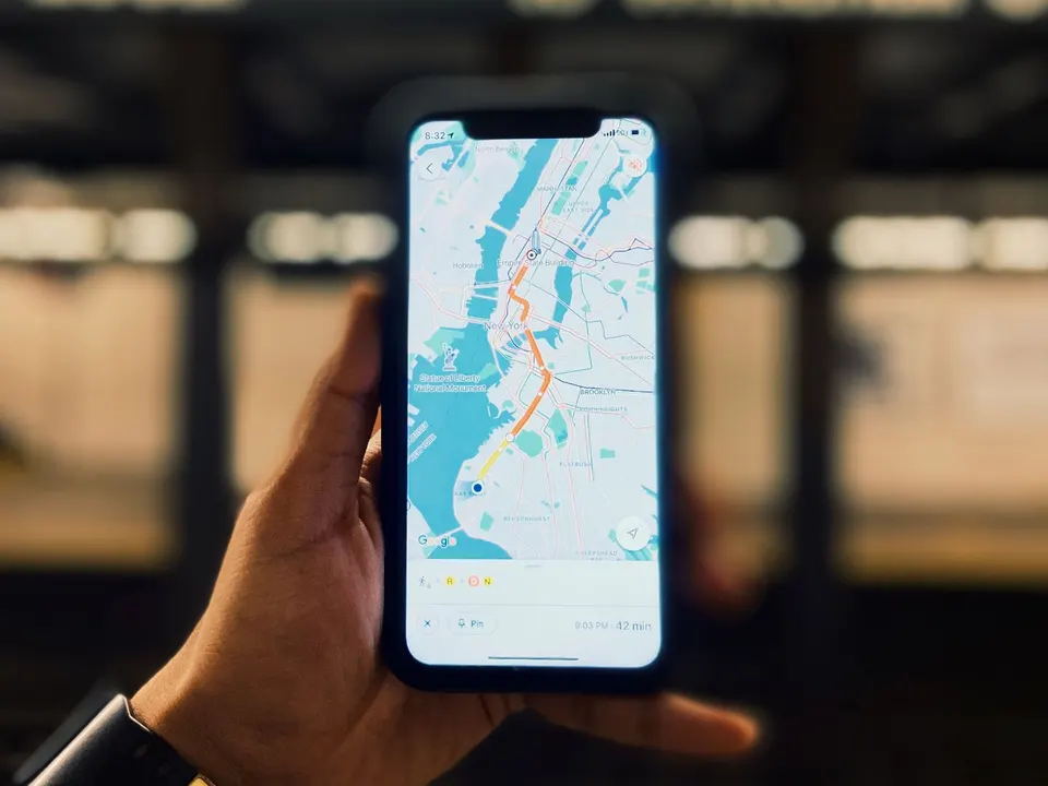 Hand holding a phone with a map on screen, as Coimbatore customers do when they look up a business on Google Maps